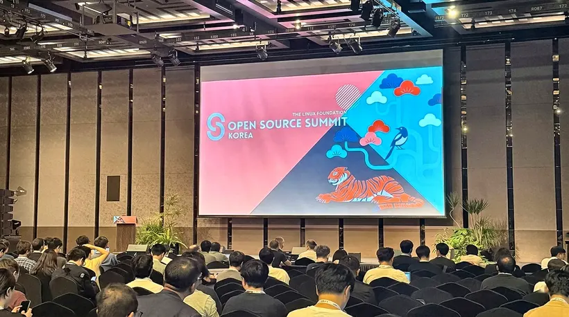 The keynote hall at Open Source Summit Korea 2026 in Seoul: attendees face a stage screen carrying The Linux Foundation Open Source Summit Korea branding and the event's tiger-and-magpie artwork.